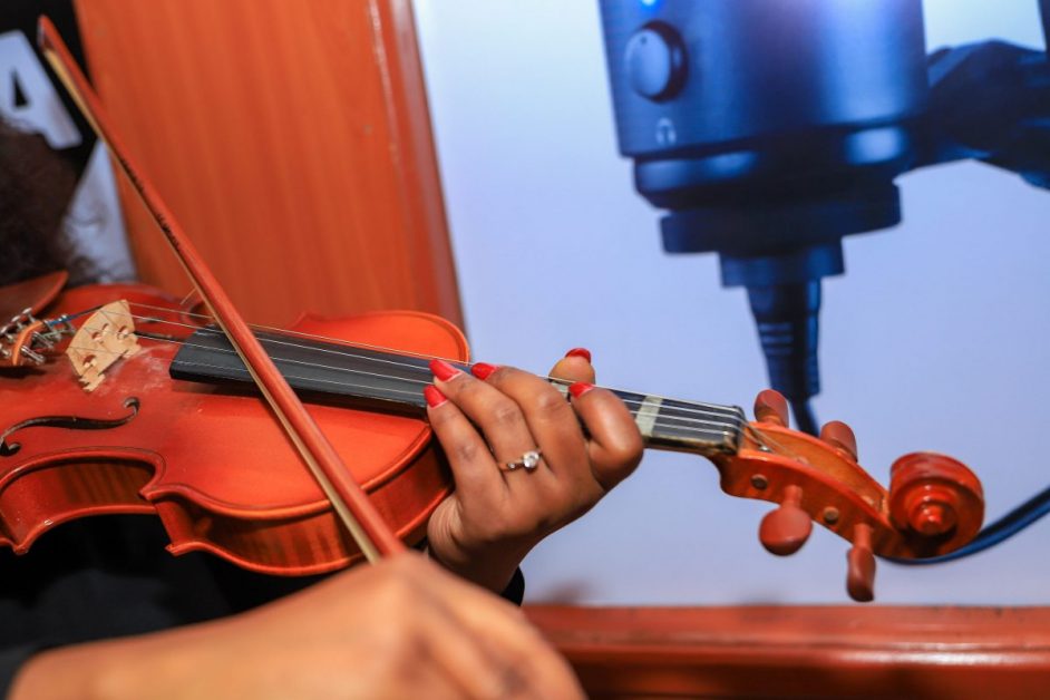 Student playing a violin in class